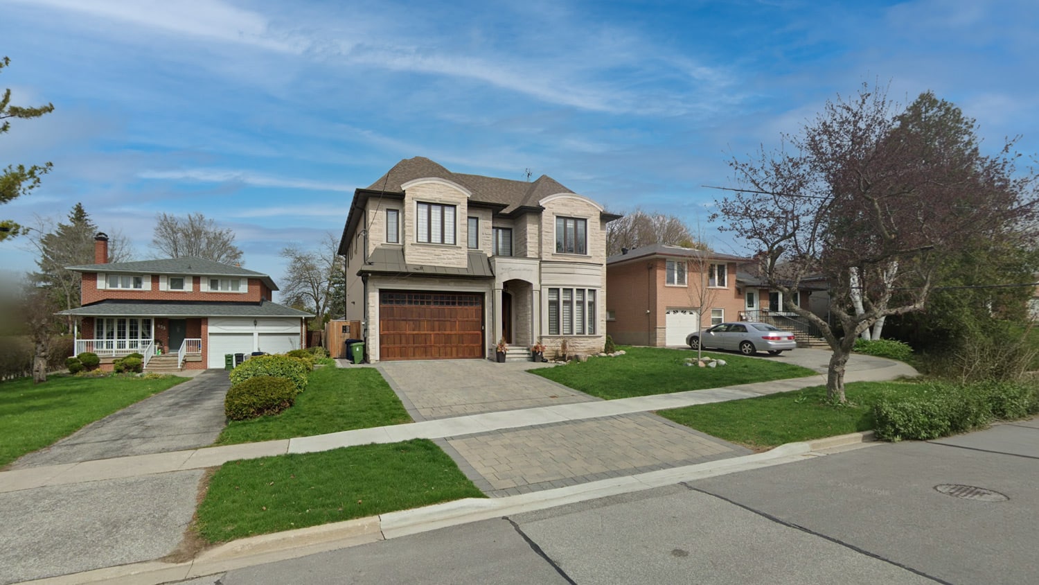 633 Conacher Dr, North York: Stone-Clad Two-Storey with Arched Dormer Detail and a Wood-Panelled Double Garage