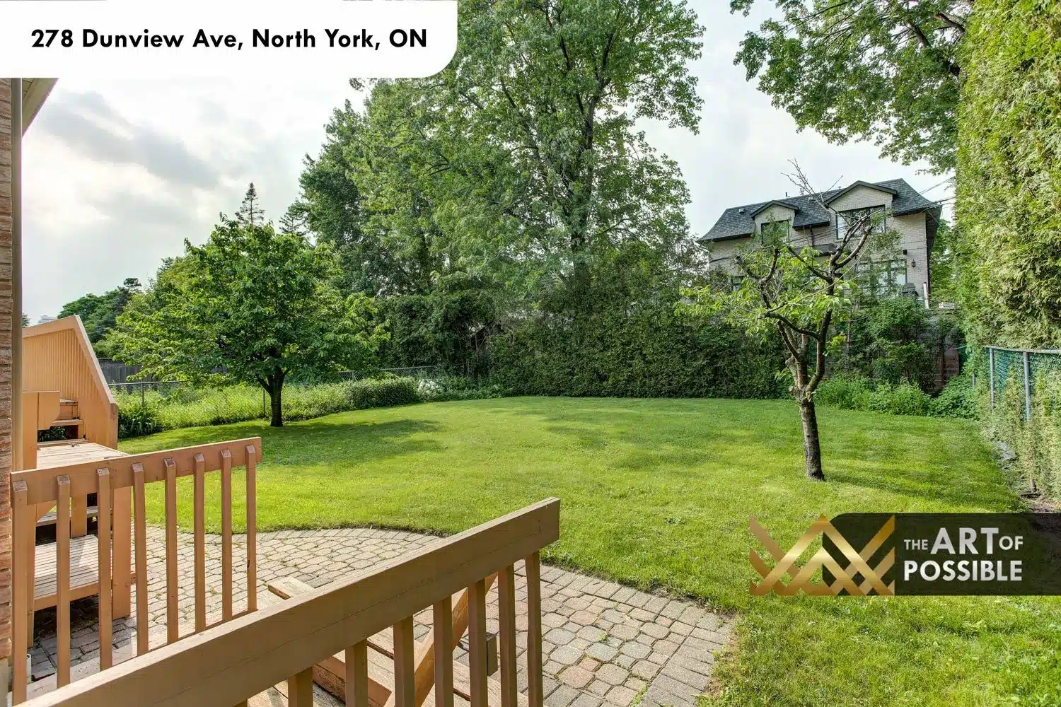 Rear deck with interlocking stone patio and deep landscaped yard at 278 Dunview Ave