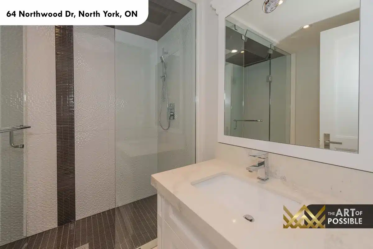Lower level bathroom with glass shower and stone vanity